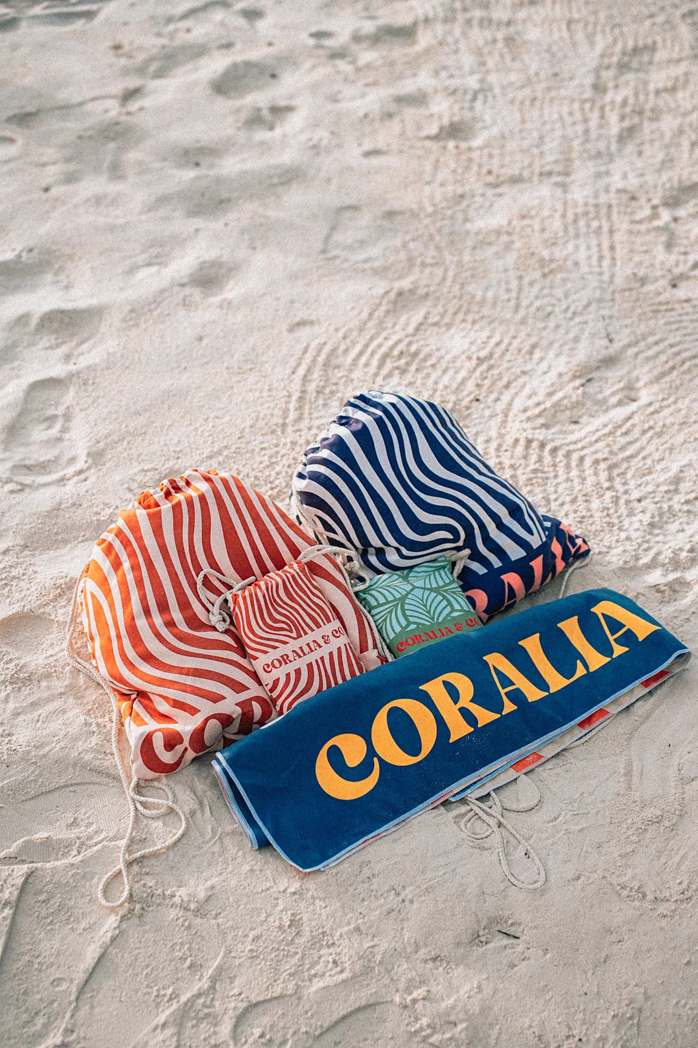 Coralia & Co. 2-in-1 Beach Towel Backpack - Coral Waves drawstring closure detail in coral orange and navy blue