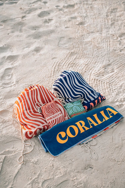 Coralia & Co. 2-in-1 Beach Towel Backpack - Coral Waves drawstring closure detail in coral orange and navy blue