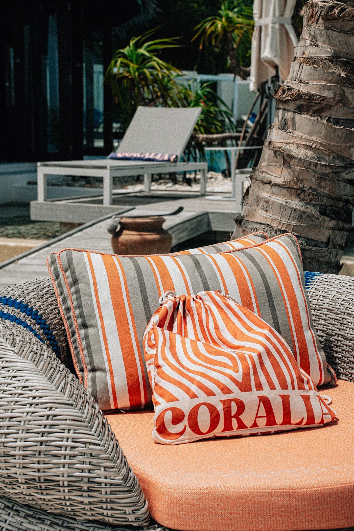 Coralia & Co. Coral Waves Beach Towel Backpack drawstring closure detail in coral orange and white