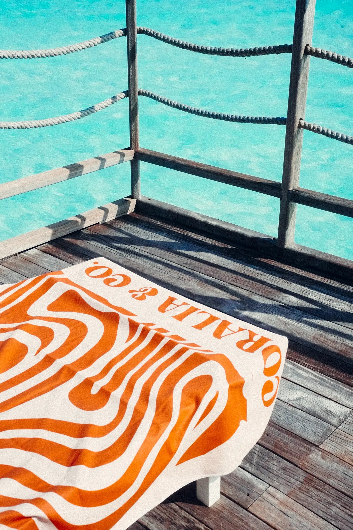 Coralia & Co. Coral Waves 2-in-1 Beach Towel Backpack - Sand-free design with coral orange and white microfiber.