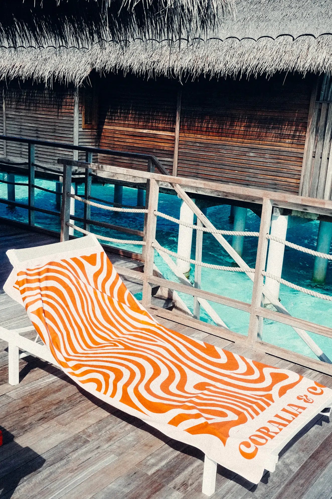 Coralia & Co. 2-in-1 Beach Towel Backpack - Coral Waves sand-free design in coral orange and white