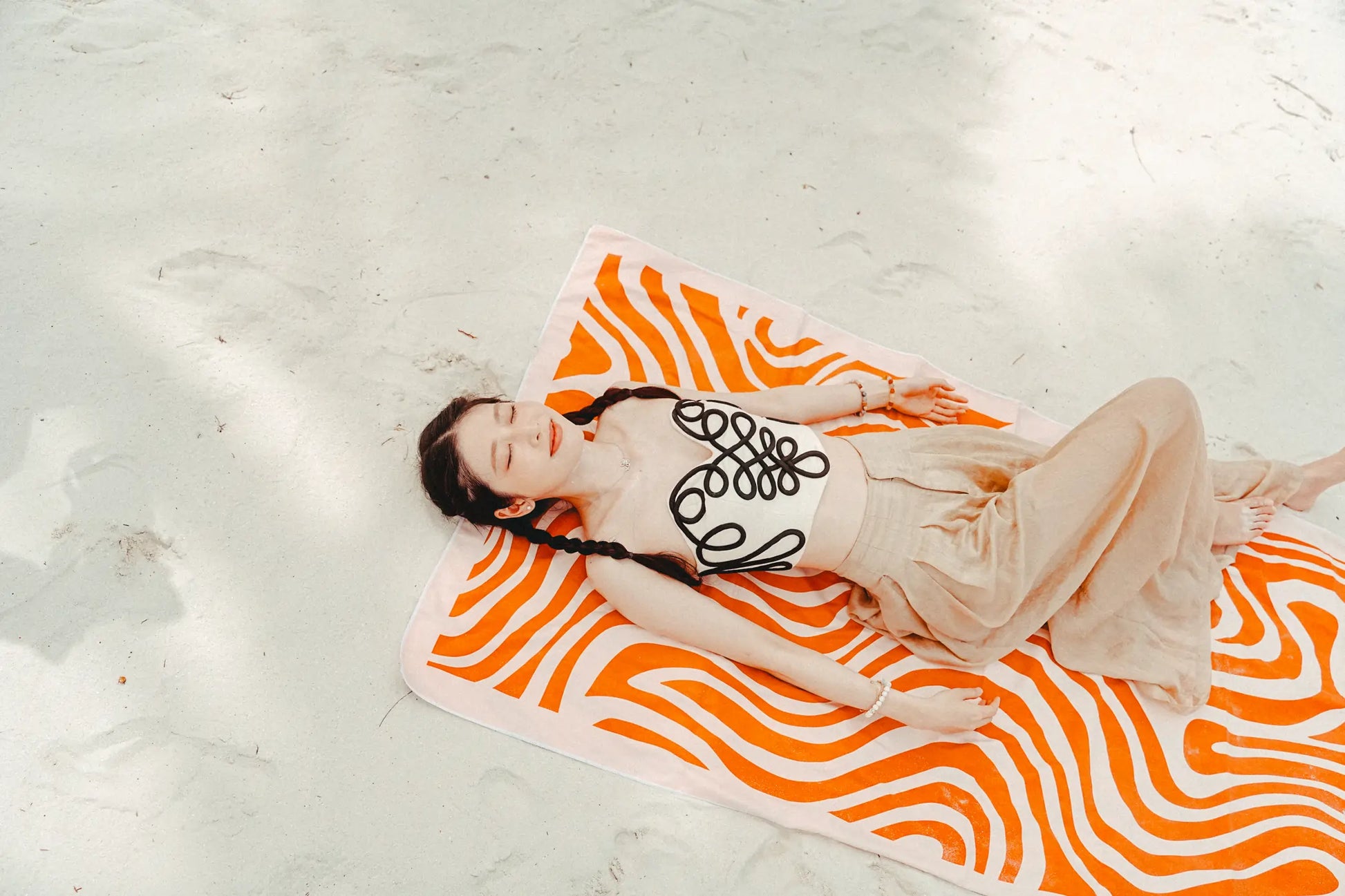 Coralia & Co. 2-in-1 Beach Towel Backpack - Coral Waves in coral orange and white, side view with sand-free design