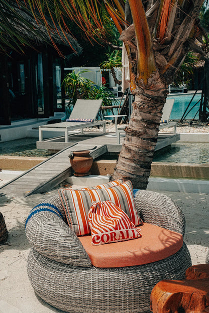 Coralia & Co. 2-in-1 Beach Towel Backpack - Ocean Breeze sand-free design close-up in orange and white