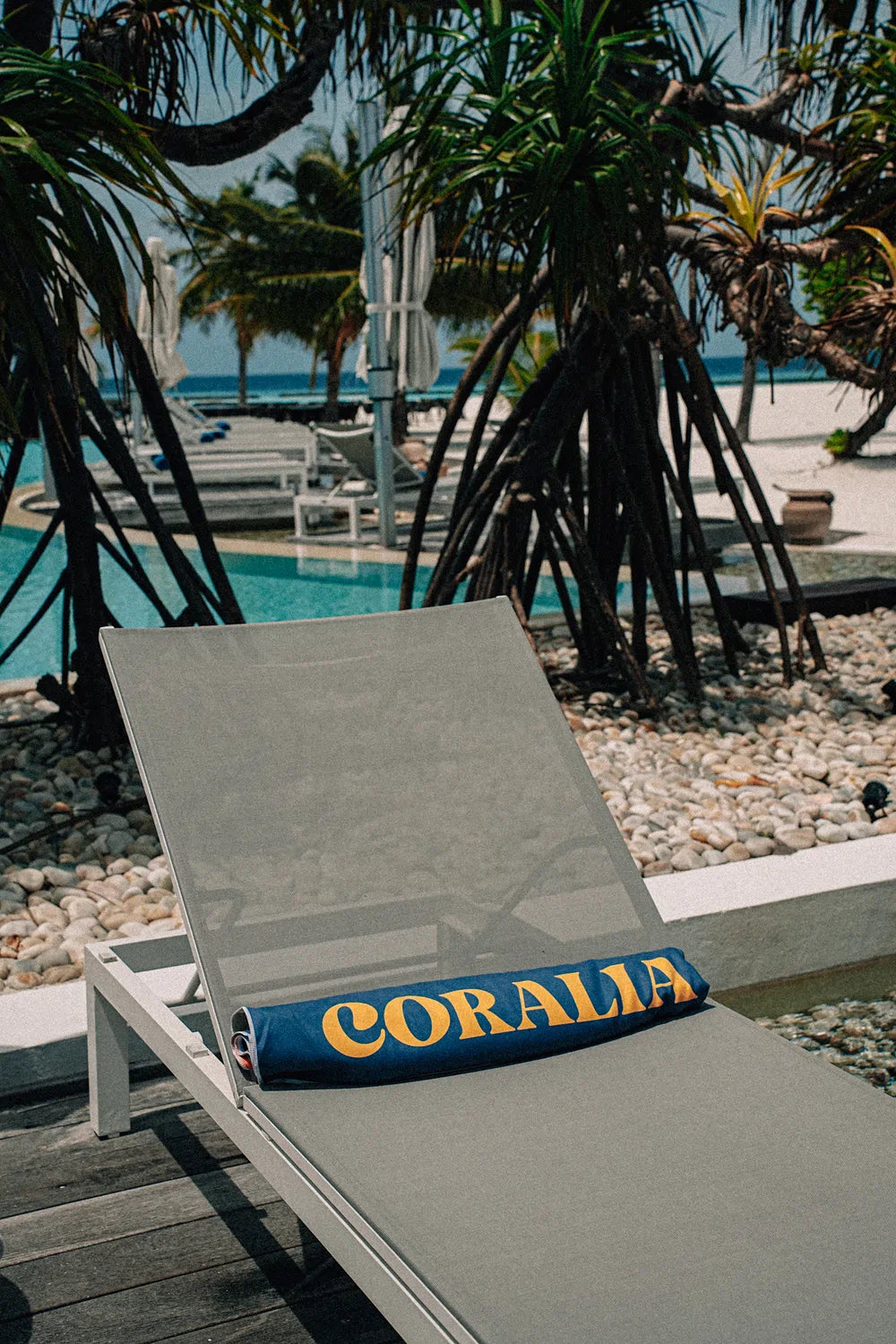 Coralia & Co. Large Quick Dry Microfiber Beach Towel - Ocean Breeze in navy blue and yellow, showcasing 2L storage space