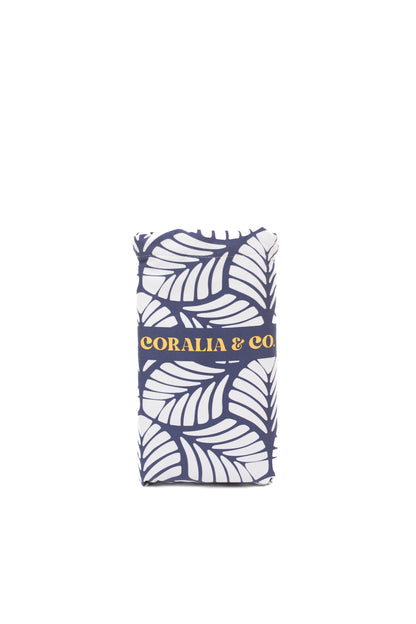 Coralia & Co. Large Quick Dry Microfiber Beach Towel - Ocean Breeze in navy blue and yellow, showing 2-in-1 design and compact style