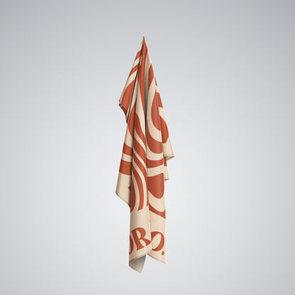 Coralia & Co. Large Quick Dry Microfiber Beach Towel in Coral Waves with sand-free quick-dry technology on the beach